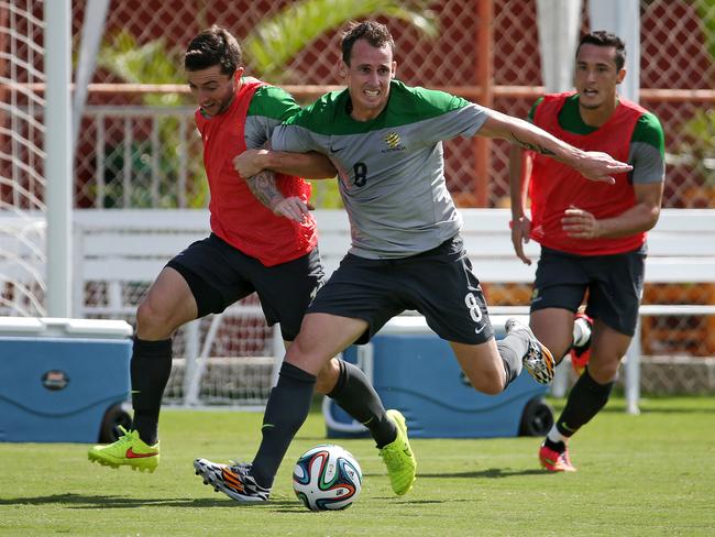 Australia's Luke Wilkshire battles with Tommy Oar in training ahead of the 2014 WC — before he copped the axe. Pic: George Salpigtidis