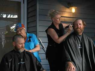 TAKE IT ALL OFF: Simon James has his head shaved by the days inspiration, Audrey Fresser, whilst Jodie Allen takes care of Shawn Fresser. Picture: Sam Flanagan