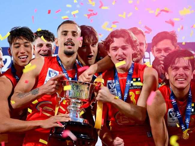 MELBOURNE, AUSTRALIA - SEPTEMBER 24: Suns players celebrate with the trophy following the 2023 VFL Grand Final match between the Gold Coast SUNS and the Werribee Tigers at IKON Park on September 24, 2023 in Melbourne, Australia. (Photo by Morgan Hancock/AFL Photos via Getty Images)