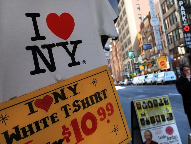 (FILES) In this file photo taken on May 10, 2010 a shirt bearing the "I Love New York" logo are displayed at a store in Times Square in New York City. As a result of a $9.2 billion budget gap for the fiscal year that began April 1, New York State's "I Love New York" tourism office is proposing to cut tourism funding by 13 percent, from $12.2 million to $10.6 million. - Milton Glaser, the graphic designer behind the iconic "I ? NY" logo, has died at 91. (Photo by SPENCER PLATT / GETTY IMAGES NORTH AMERICA / AFP)