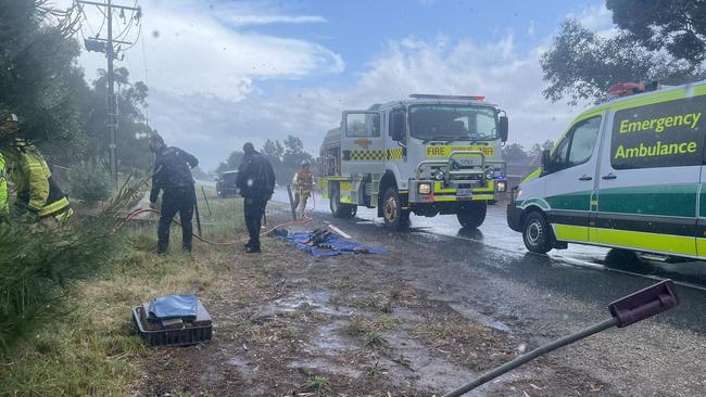 Emergency services work to retrieve a woman after losing control of her car in the wild weather. Picture: Keziah Sullivan/Nine News Adelaide