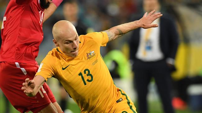 Australia's Aaron Mooy takes on a Syrian defender after replacing Brad Smith on Tuesday night.