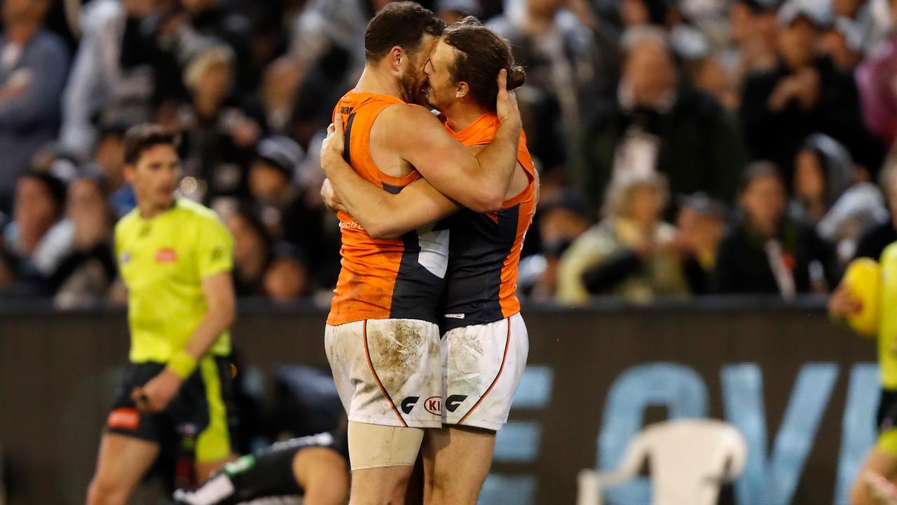 Shane Mumford celebrates with Phil Davis on the final siren. Picture: Getty Images