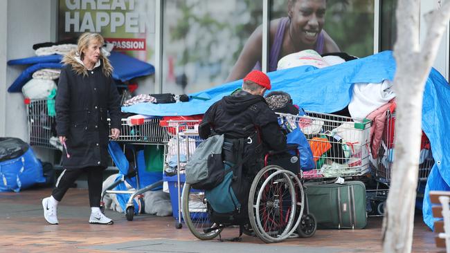 Homeless store their belongings under a giant tarp outside the entrance to Southport TAFE in the middle of town at Nerang Street, Southport. Picture: Glenn Hampson