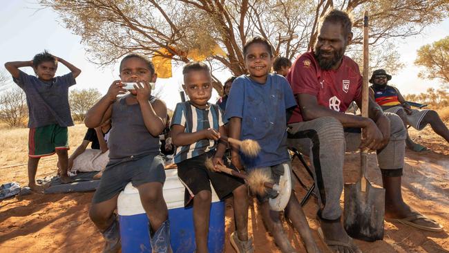 ​Graham Hoosan and son Hussain (in striped shirt) with relatives at Santa Teresa, south of Alice Springs, to watch the races. Picture: Liam Mendes