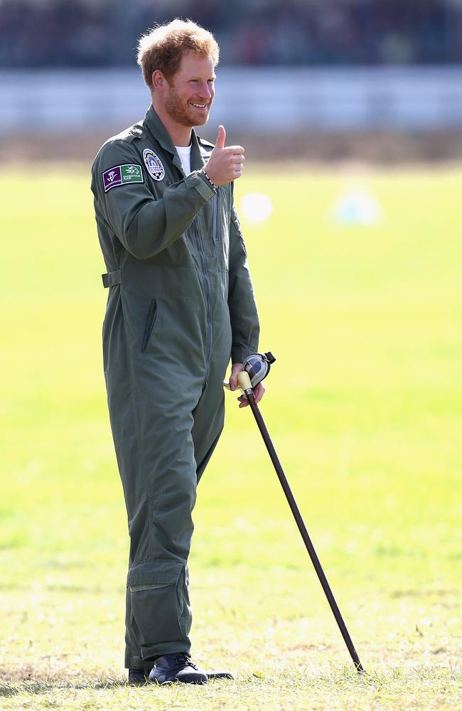 Prince Harry holds on to year old RAF veteranTom Neil’s walking stick as he watches the Spitfires take off on the airfield at Goodwood Aerodrome during a Battle of Britain Flypast at Goodwood in Chichester, England. Picture: Getty