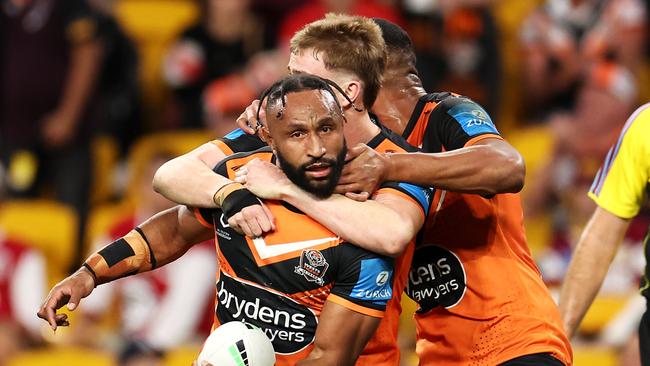 BRISBANE, AUSTRALIA - MAY 19: Justin Olam of the Wests Tigers celebrates with his team mates after scoring a try during the round 11 NRL match between Wests Tigers and Dolphins at Suncorp Stadium, on May 19, 2024, in Brisbane, Australia. (Photo by Hannah Peters/Getty Images)