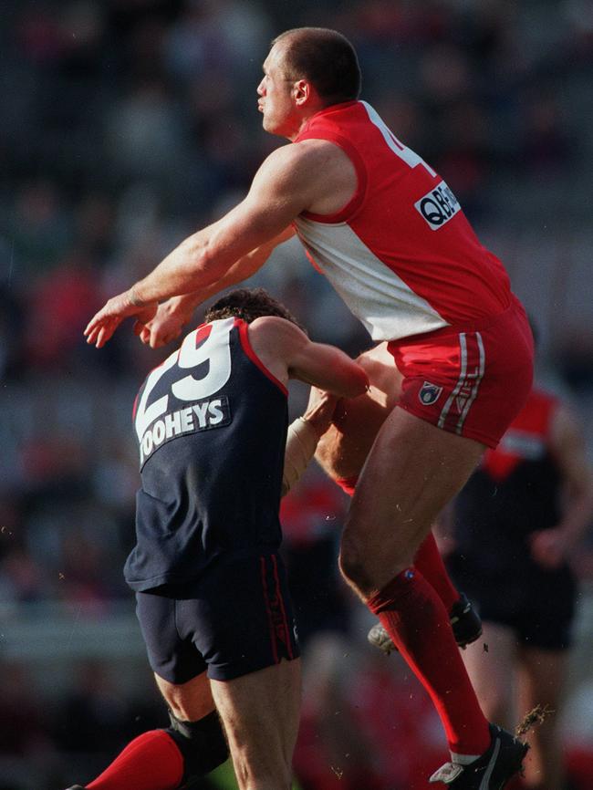 Smith takes a battering from a Tony Lockett crunch.