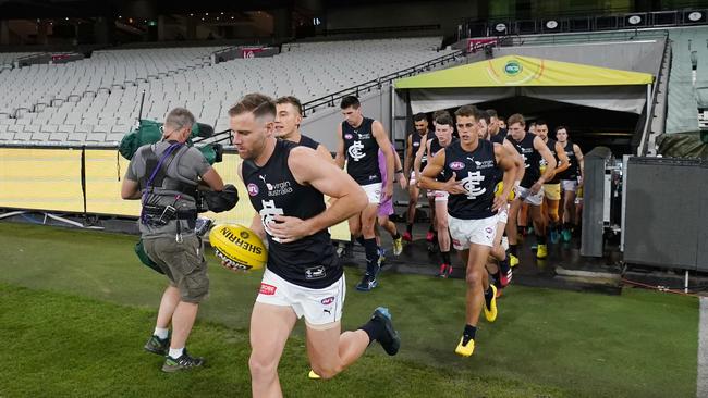 Sam Docherty leads Carlton out in his first game in more than two years.