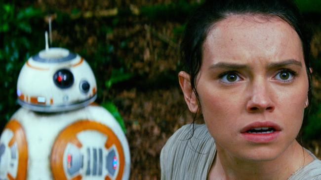 Daisy Ridley, right, as Rey, and BB-8, in Star Wars: The Force Awakens.