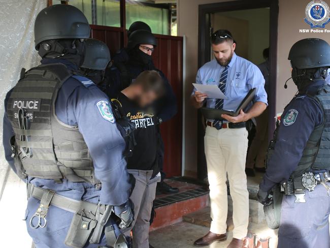 NSW Police images of Mr Small during his arrest over a scam targeting the fraudulent sale of hay to drought-stricken farmers across NSW.