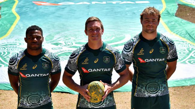 Rugby players Filipo Daugunu (L), Dane Haylett-Petty (C) and Harry Wilson pose in the Wallabies Indigenous jersey.