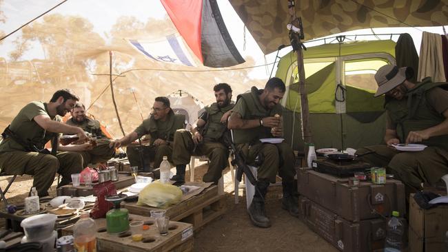 Israeli soldiers of the artillery unit rest in their tent at the Israeli side of the border with the Gaza Strip. Picture: Getty