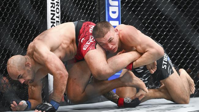 Navajo Stirling, right, takes Ivan Erslan, left, to the mat during their UFC 315 light heavyweight fight. Graham Hughes/The Canadian Press via AP.