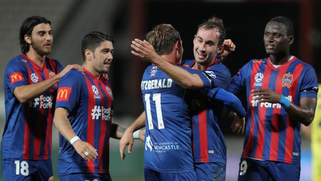 Nick Fitzgerald celebrates with his Jets’ teammates after scoring in Newcastle’s 3-0 win over Wellington Phoenix. Picture: Matt King/Getty Images