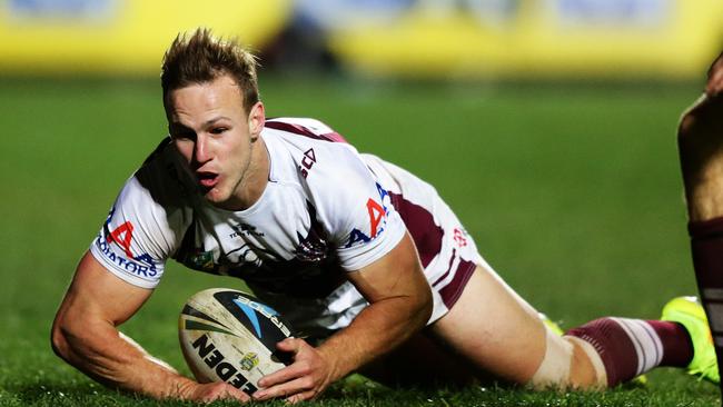 Manly's Daly Cherry-Evans kicks ahead to score a try during the Manly v Wests Tigers rugby league game at Brookvale Oval, Sydney. Pic Brett Costello