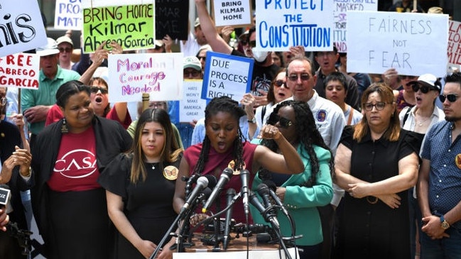 Abrego Garcia’s wife, Jennifer Vasquez Sura, left of the speaker and wearing black, participated in a May demonstration in his support. Picture: Carol Guzy/Zuma Press