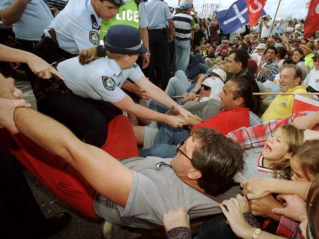 A young girl screams as a sacked union dockside worker is removed by police from the picket line outside Patricks Stevedore's Port Botany terminal in Sydney April 14.  Around 22 people were taken away by police to waiting vans during an unsuccessful bid to allow a truck to enter Patrick's terminal. Patricks sacked 1,400 dockworkers across Australia on April 8 and as a result, union members are manning 24-hour picket lines, refusing to let any trucks past to remove containers. - PBEAHUMBFAW