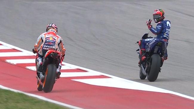 Maverick Vinales gesticulates at Marc Marquez after getting held up during qualifying.