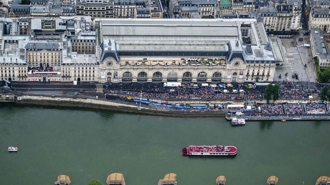 A photograph taken from an helicopter on July 26, 2024 shows an aerial view of the delegation boats navigating on the Seine. (Photo by Lionel BONAVENTURE / POOL / AFP)