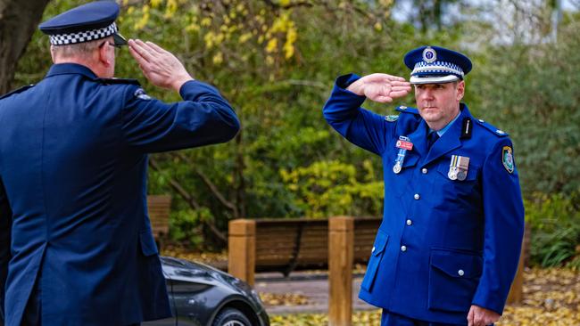 The police chiefs ‘ solemn salute. Picture: AAP Image/Simon Dallinger