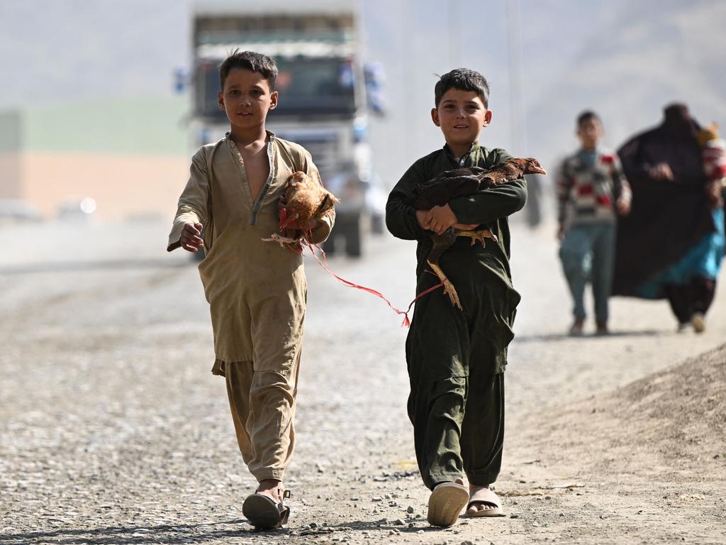 Afghan refugee boys carrying hens arrive to cross the Pakistan-Afghanistan border, following the Pakistani government’s decision to expel 1.7 million people illegally staying in the country. Picture: Farooq Naeem/AFP