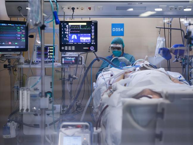 A healthcare worker wearing a protective suit attends to a COVID-19 coronavirus patient at the Intensive Unit Care (ICU) of the Vall d'Hebron Hospital in Barcelona. Picture: AFP