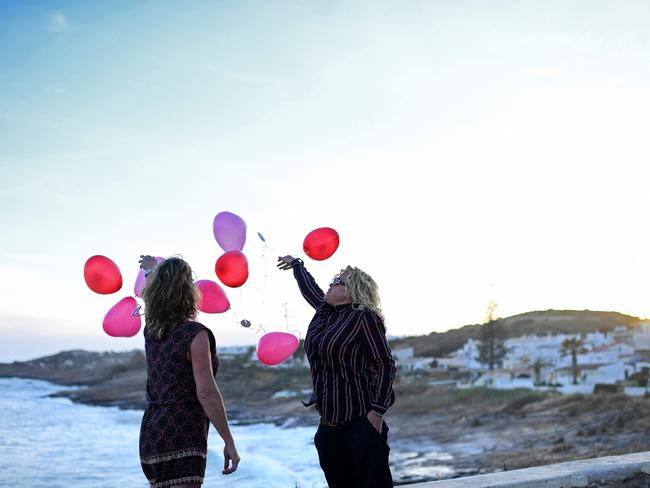 Two people release balloons in Praia da Luz, near Lagos, to mark the 10th anniversary of the disappearance of British child Madeleine McCann. Picture: AFP