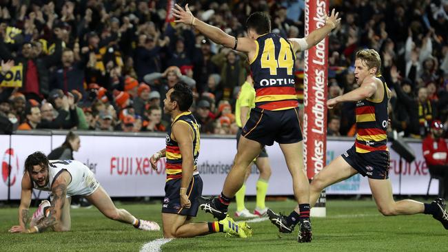 Eddie Betts celebrates a trademark goal from the boundary line with Lachie Murphy and Rory Sloane against the Giants in 2019. Picture: Sarah Reed