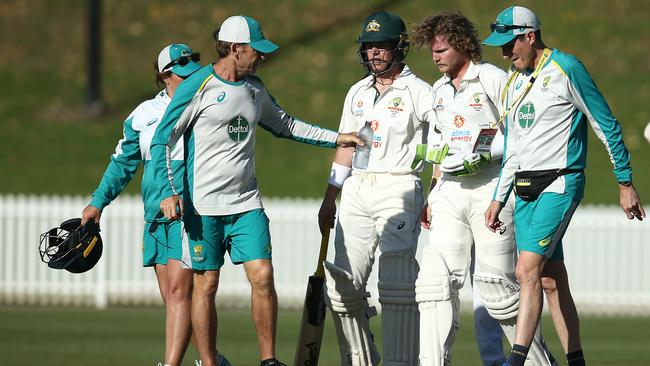 Pucovski is assisted from the field without his helmet, which appeared to be dented by the blow. Picture: Getty Images