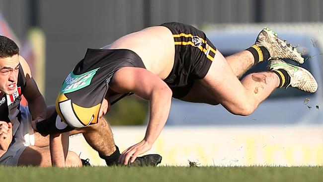 Morwell’s Brandon Mcauliffe gets his shirt ripped off in a tackle against Sale last year. Picture Yuri Kouzmin