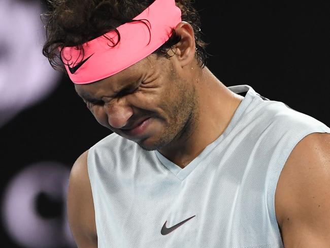 Rafael Nadal grimaces as he walks on court while preparing to serve to Croatia's Marin Cilic.