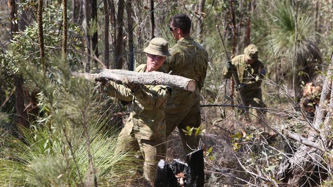 Defence force personnel working to clear maintenance tracks for firefighters in the Lower Beechmont area. Picture: Glenn Hampson