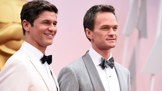 Host arrives ... Neil Patrick Harris with husband David Burtka on the Oscars red carpet. Picture: AP