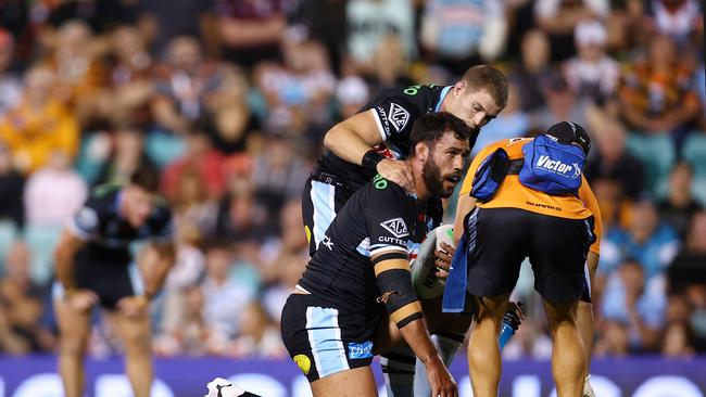 SYDNEY, AUSTRALIA - MARCH 23: 1 Toby Rudolf of the Sharks is assessed by the trainer during the round three NRL match between Wests Tigers and Cronulla Sharks at Leichhardt Oval, on March 23, 2024, in Sydney, Australia. (Photo by Jeremy Ng/Getty Images)