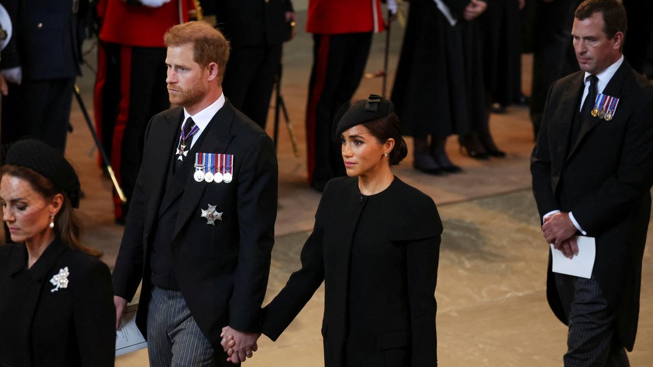 Prince Harry and Meghan Markle broke ranks by holding hands as they left the service at Westminster Hall. Picture: Getty Images.