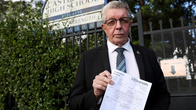 Castle Hill MP Ray Williams pictured outside Castle Hill High school with a asbestos report. Asbestos has been found at Castle Hill High School. Picture by Damian Shaw