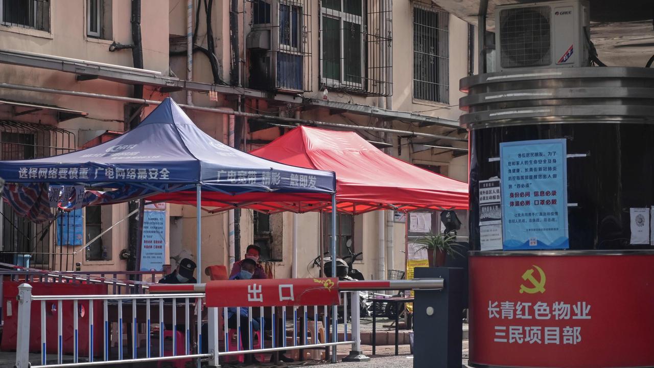 Security stand outside a residential compound where five new cases of the COVID-19 coronavirus were found in Wuhan. Picture: Hector Retamal/AFP