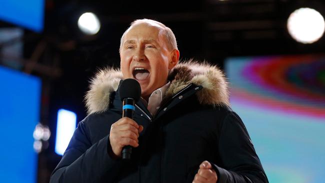 Vladimir Putin addresses the crowd during a rally and a concert celebrating the fourth anniversary of Russia's annexation of Crimea at Manezhnaya Square in Moscow in 2018.