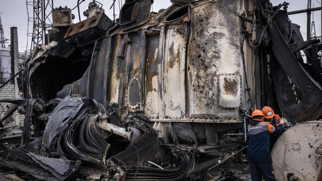 Workers dismantle an autotransformer after the Ukrenergo high-voltage power substation was hit by a Russian missile strike. Picture: Getty Images