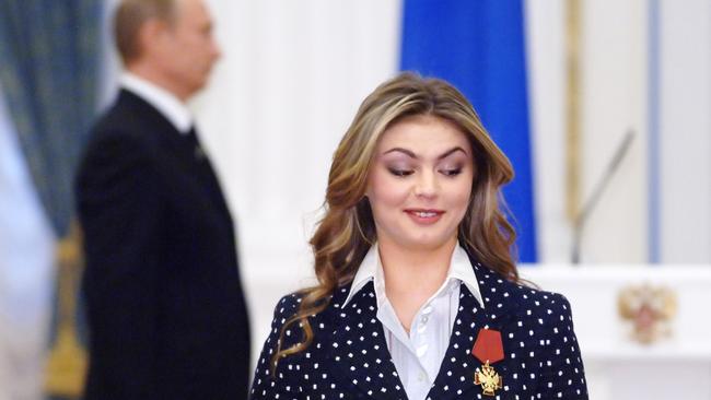 Alina Kabayeva and Vladimir Putin in the background.