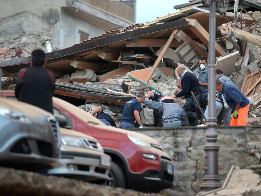 Rescuers search for victims in the rubble after a strong earthquake hit Amatrice on August 24, 2016. Picture: AFP