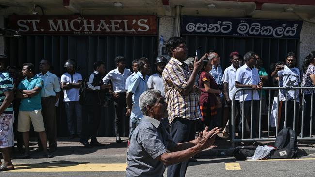 People pray outside the St. Anthony's Shrine in Colombo on April 22, one day after the attacks. Picture: AFP 