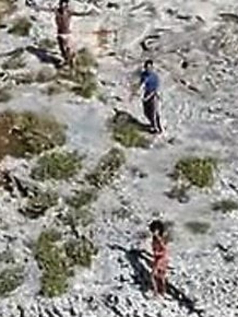 The two men and one woman swam to the island when their boat capsized.