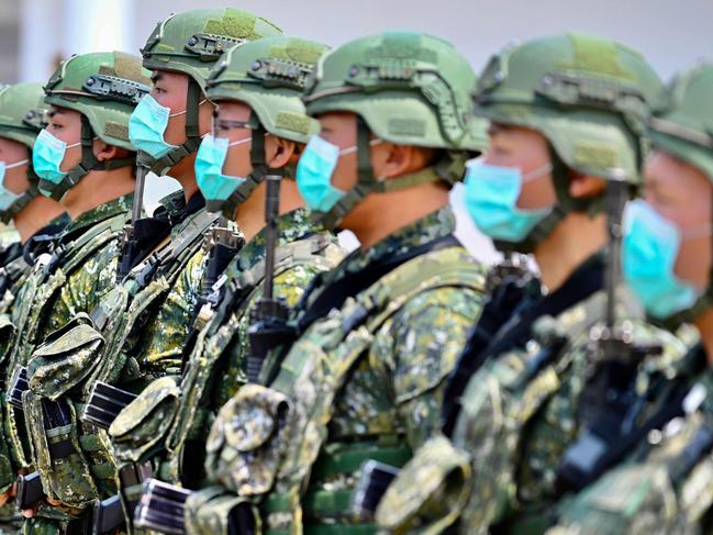 Soldiers wearing face masks amid the COVID-19 coronavirus pandemic listen to an address by Taiwan President Tsai Ing-wen during her visit to a military base in Tainan, southern Taiwan, on April 9, 2020. - Taiwan currently has just 375 confirmed Covid-19 patients and five deaths despite its close proximity and trade links with China where the pandemic began, but the island and its 23 million inhabitants remain locked out of the World Health Organisation (WHO) and other international bodies after Beijing ramped up its campaign to diplomatically isolate Taiwan and pressure it economically and militarily. (Photo by Sam Yeh / AFP)