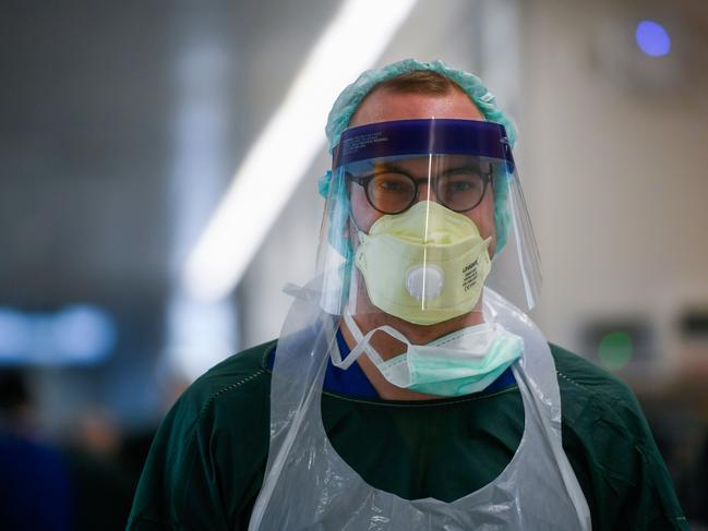 A nurse walks in the corridor at the isolation ward of the University hospital of Essen, western Germany, on April 1, 2020. - Two patients from France infected with the new coronavirus COVID-19 were to be transported to the Unibversity hospital of Essen for further treatment. (Photo by Ina FASSBENDER / AFP)