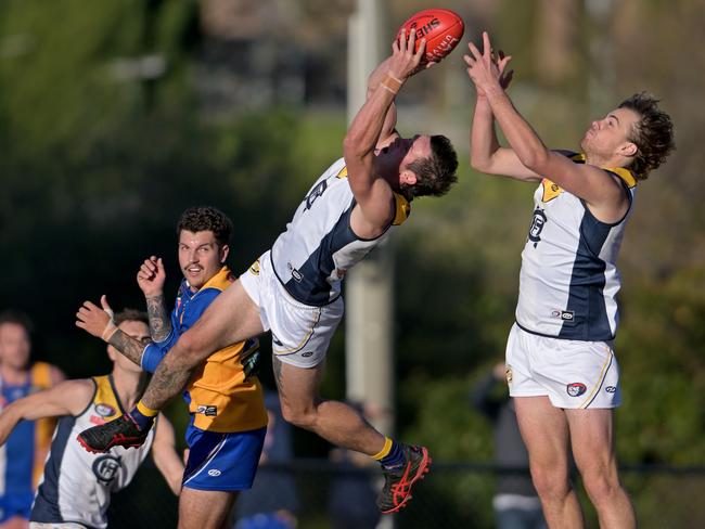 NFNL: Hurstbridge’s Jake Richards takes a speccie. Picture: Andy Brownbill