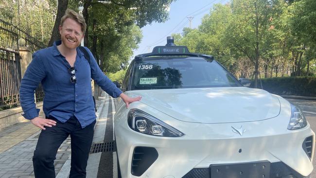 The Australian's North Asia correspondent Will Glasgow with a Baidu robotaxi in Wuhan