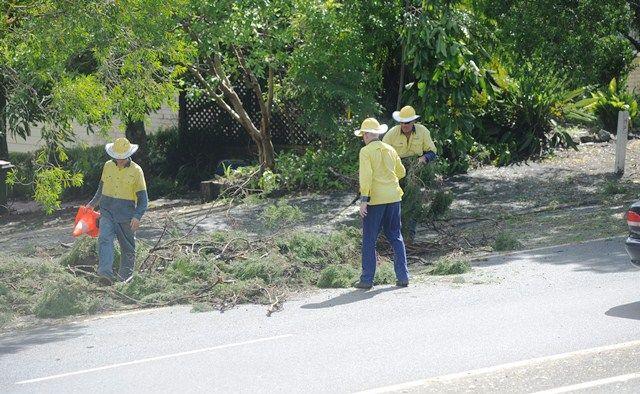 Lismore City Council workers assist with the cleanup along the Bruxner Highway near Goonellabah.