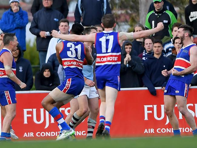 Keilor players, including Kane Barbuto (right), move into celebration mode. Picture: Andy Brownbill